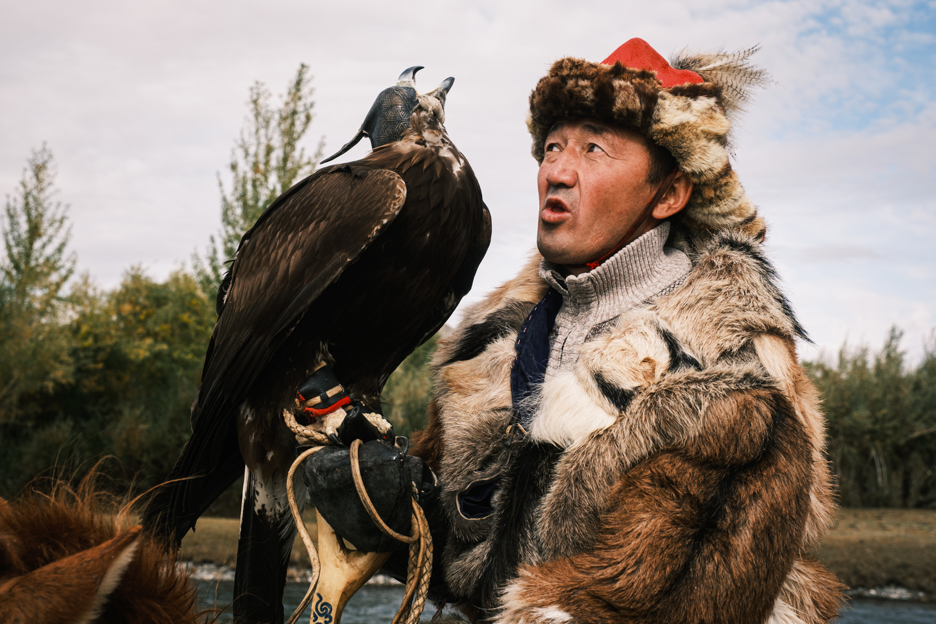 Eagle hunter talking to his eagle.