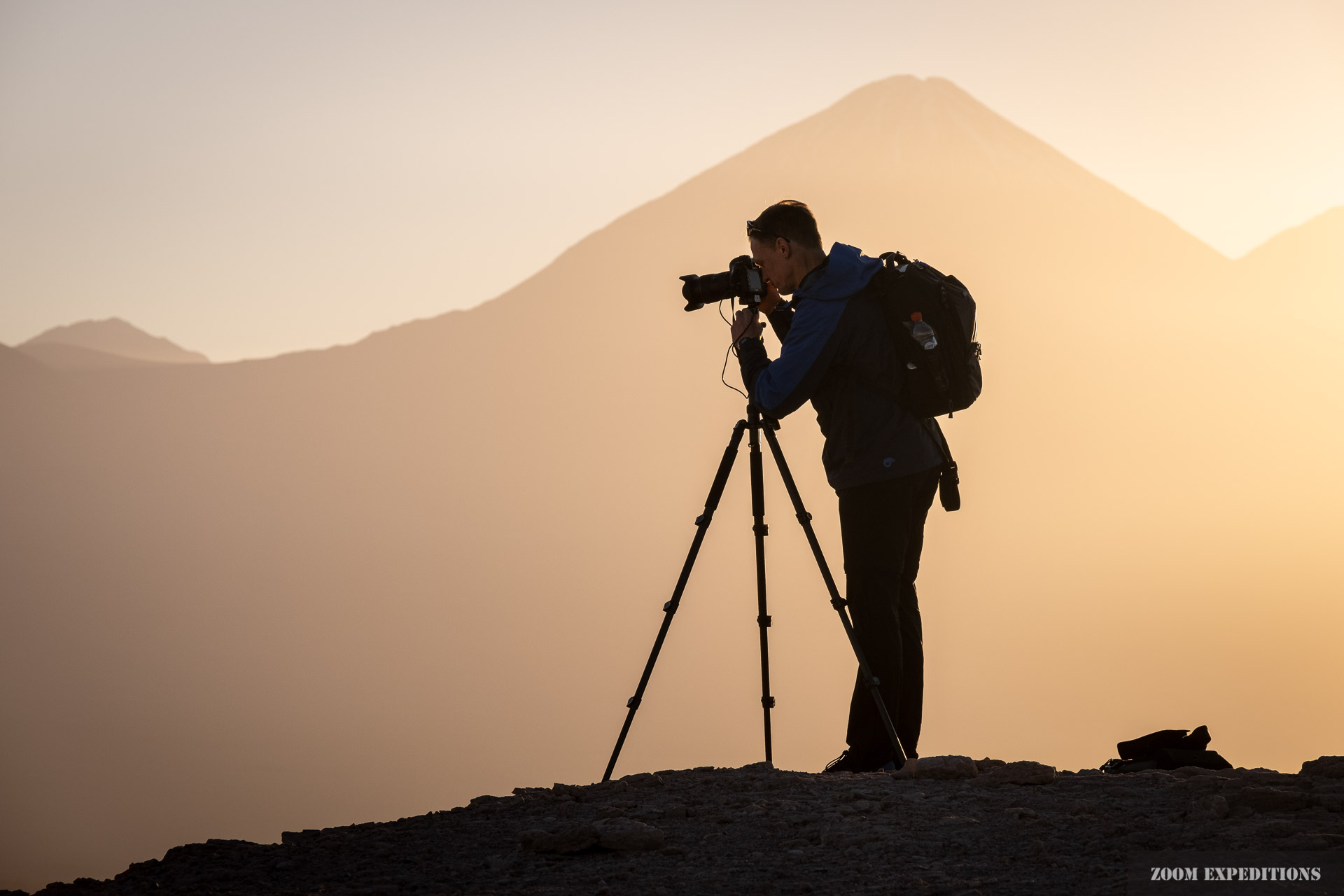 photographers silhouette in front of volcano Atacama desert