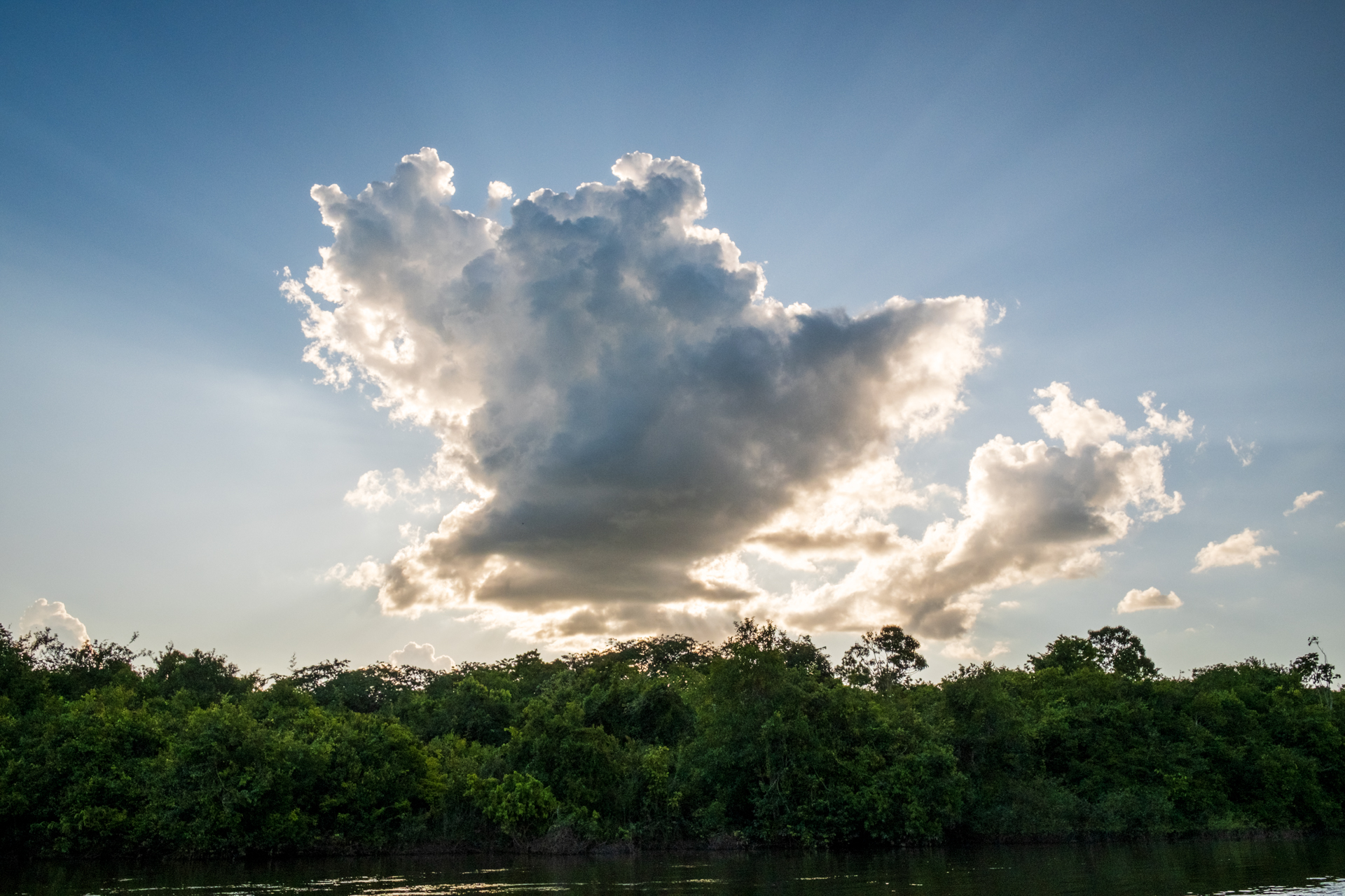 Sun rays behind a cloud in Guyana.