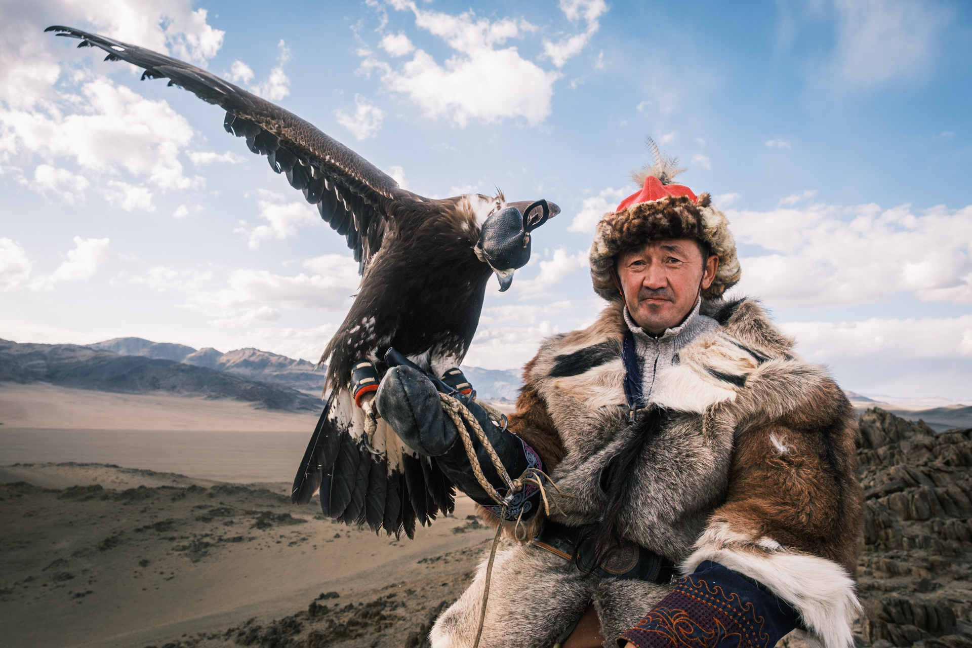 Portrait of an eagle hunter with his animal.